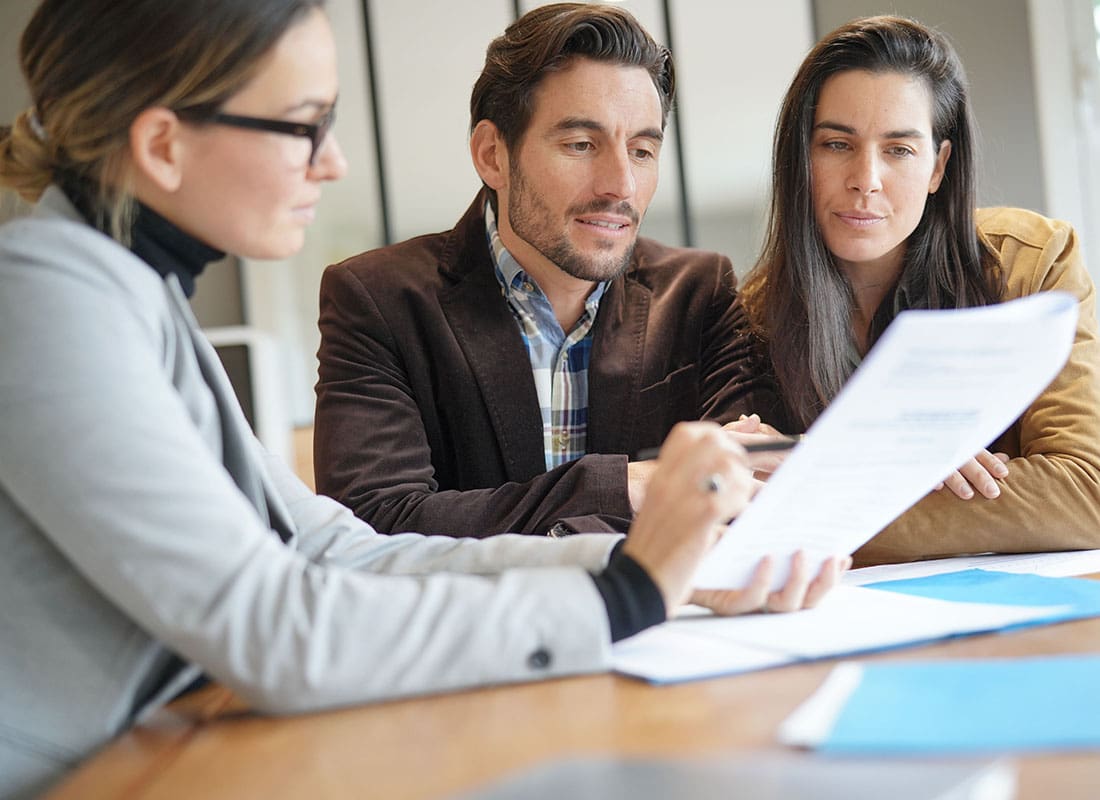 Policy Review - Insurance Agent and Family Discussing Insurance Needs During a Meeting