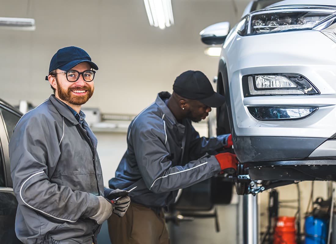 Business Insurance - Two Auto Technicians Working on a Car