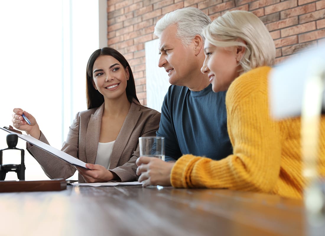 Contact - Friendly Agent Sits With a Elderly Couple in Her Office